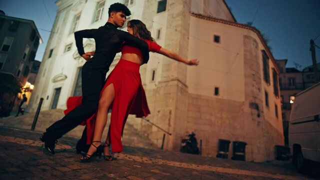 Beautiful Couple Dancing a Latin Dance on the Quiet Street of an Old Town in a City. Sensual Dance by Two Professional Dancers in the Evening in Ancient Culturally Rich Tourist Location.