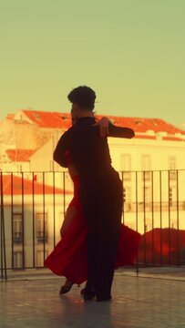 Vertical Screen: Couple Dancing a Latin Dance Outside the City with Old Town in the Background. Sensual Dance by Two Professional Dancers on a Sunset in Ancient Culturally Rich Tourist Location.