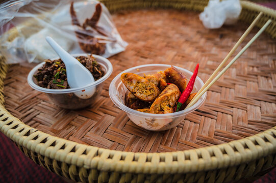 Khantoke Dinner in small market in Sapan Village At nan Thailand .A khantoke or khantok is a pedestal tray used as a small dining table by the Lanna people (of northern Thailand)