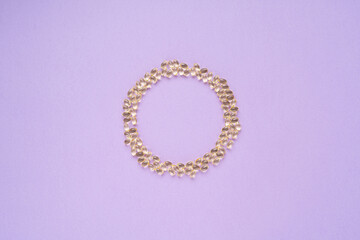 Circle of omega pills on a purple background