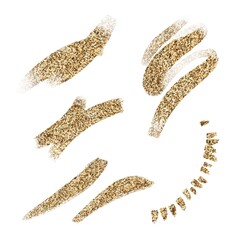 Strokes of gold glitter make up on white ground