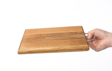 female hands hold empty rectangular brown wooden chopping board on white background