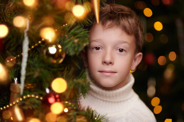 happy boy by xmas tree