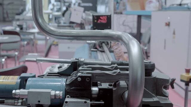 New, modern, powerful industrial equipment for high-quality bending of metal pipes and profile tubes. Shot in motion. Closeup
