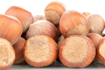 Several organic hazelnuts, close-up, isolated on white.