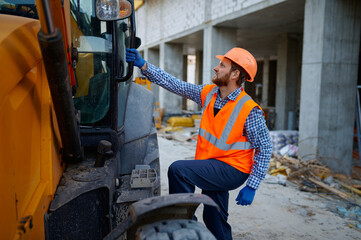 Fototapeta na wymiar Builder contractor gets into heavy machinery cab