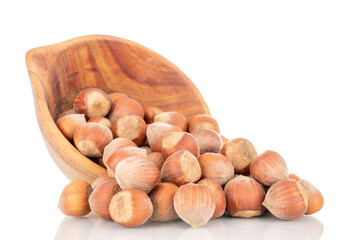 Several organic hazelnuts with a wooden cup, close-up, isolated on white.