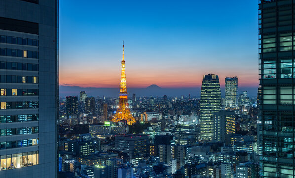 Tokyo skyline at night with view of the Tokyo Tower and Mount Fuji