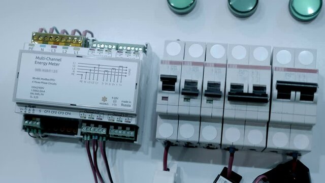 Row of electric switches and multichannel electricity meter (meter of electrical network parameters) is designed for energy management and monitoring the quality of power supply. Shot in motion. Close