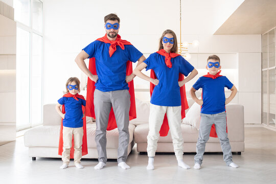 Happy family in superhero costumes