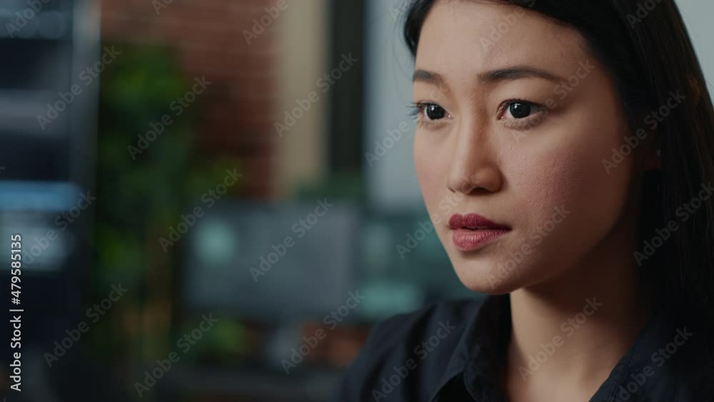 Poster closeup portrait of focused asian coder writing online cloud computing code and smiling sitting at d