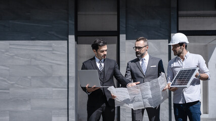 businessman or owner meeting building consults engineering team design of the building solar cell system or energy engineer plan project under construction. clean and green alternative energy concept. © mrk3PHOTO