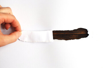 Hand tear a strip of white paper