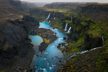 waterfalls at a blue glacial river in the southern highlands of iceland	
