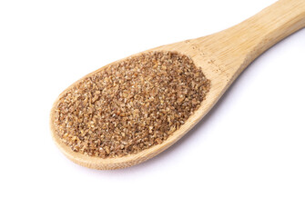 Ground whole wheat on a spoon isolated over white background