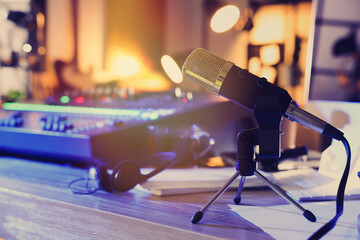Microphone near professional mixing console on table in radio studio