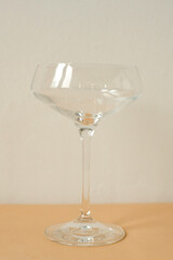empty glass for cocktail on white and  peachy background