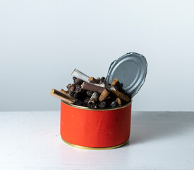 Cigarette butts in a tin can