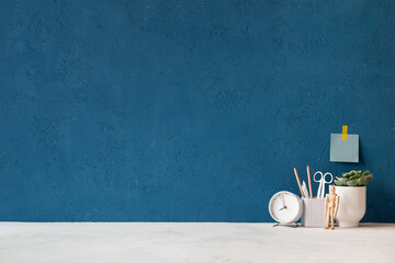 Home office desk with blue wall and white table mock up.	
