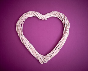 Heart made of white wooden strips on a purple background. Text space. Valentine's Day, weddings, vintage. Minimal style. Top view. Flat lay.