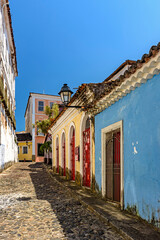 Colorful facades of colonial-style houses on a cobblestone street in the Pelourinho neighborhood of Salvador, Bahia