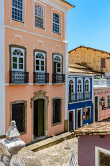 Old olorful facades of colonial-style houses on a cobblestone street in the Pelourinho neighborhood of Salvador, Bahia