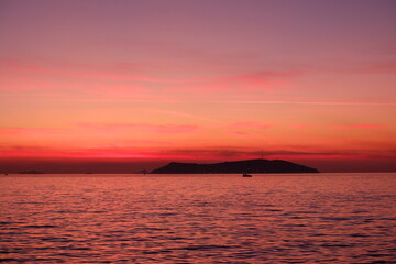 Fototapeta premium amazing sunset view with sea island and ferryboat
