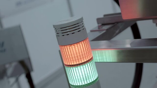 Industrial signal pole, emergency luminaire, LED, tricolor, warning signal - red, yellow, green - in industrial production, warns of the status of equipment. Shot in motion. Closeup
