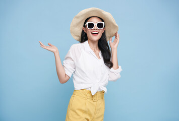Young elegant beautiful Asian woman dressed in summer clothes smiling and pointing to empty copy...