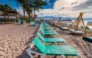 Naklejka na ściany i meble Morning on sandy beach in Eilat - famous tourist resort and recreational city in Israel