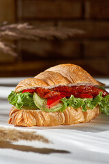 Croissant sandwich Vegan - Grilled zucchini, bell peppers, sun-dried tomatoes and pesto sauce.