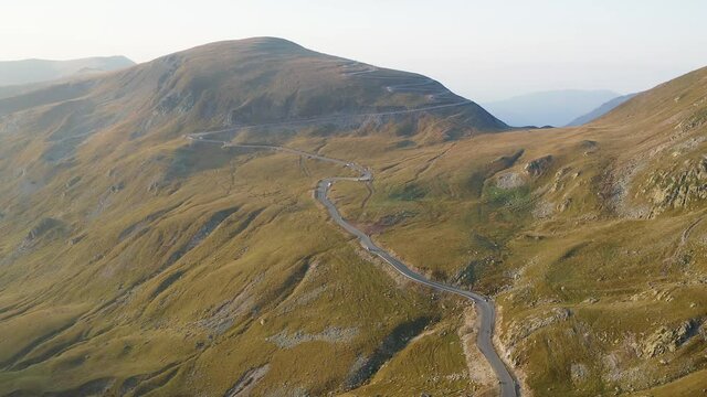 Amazing mountain road. 4K aerial view of Transalpina motorway from Romania during a summer sunrise.