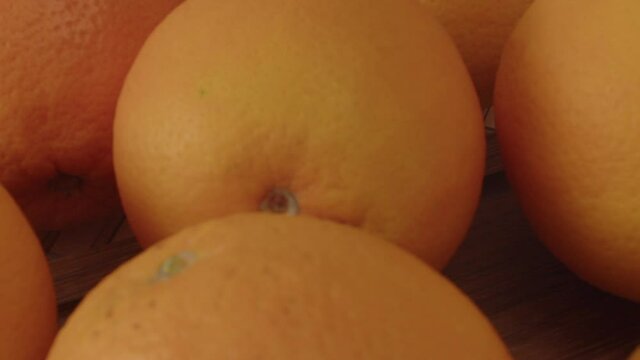 Revealing shot of a group of oranges on kitchen table