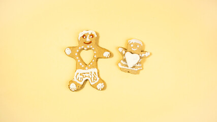 Two gingerbread man. Gingerbread made by children. White human heart stolen by a gingerbread girl. Homemade cookies.