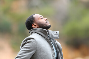 Man with black skin in winter breathing fresh air