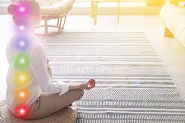 Woman meditating on wicker mat at home. Scheme of seven chakras, illustration