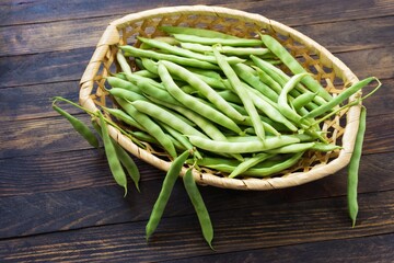 Bean pods in wicker baskets. Kitchen scene in vintage style.