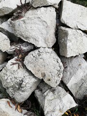 Stones and rocks. An old crumbling wall with a beautiful, rough structure. 
