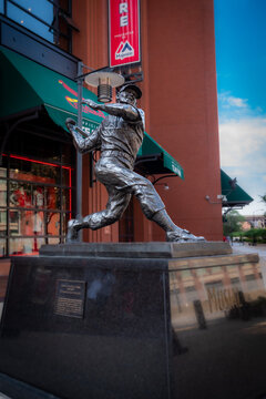 Saint Louis, MO—June 15, 2019; statue of player Stan Musial  stands in front of Major League Baseballs Cardinals team store at Busch Stadium.