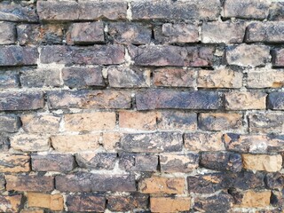 Brick. Old, crumbling brick wall with a beautiful porous and rough structure. Medieval. 