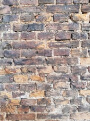 Brick. Old, crumbling brick wall with a beautiful porous and rough structure. Medieval. 