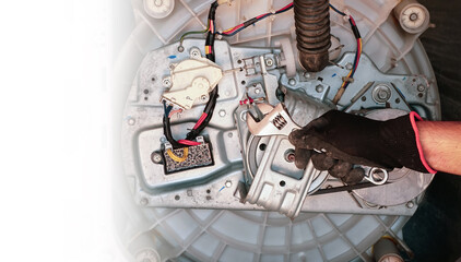 Repairman repairs the washing machine. services for the repair of household appliances at home, washing machine mechanism.                                                                  