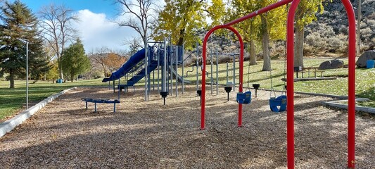 New children's playground painted in different colors. Clear autumn day.