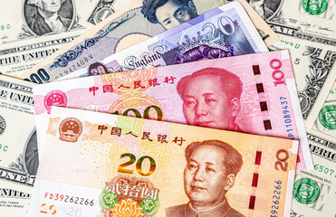 Various banknotes of Chinese and other currency on the dollars background