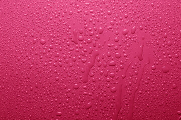 Water drops on pink color  surface