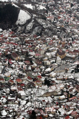 Old town of Brasov, Romania from above. Beautiful winter cityscape. 