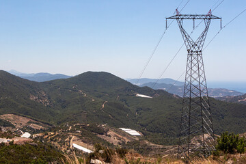 Obraz premium Black power line is on the blue sky background. mountain landscape