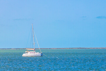 Luxury travel with yacht on Holbox island turquoise water Mexico.