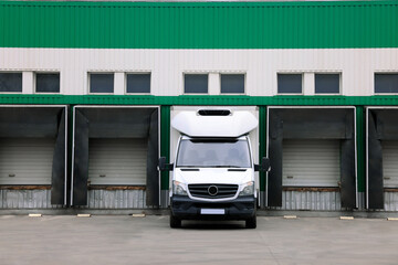 Truck near loading dock of warehouse outdoors. Logistics center
