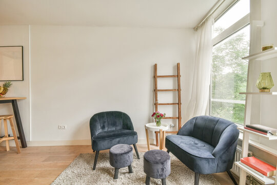 Spacious living room with armchairs and chairs near table